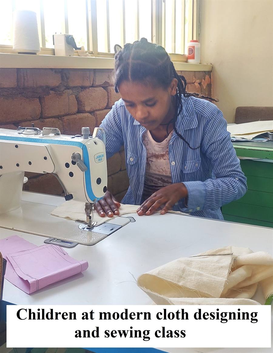 A young woman practises on a sewing machine during a vocational training class.